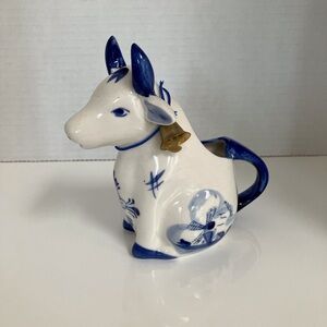 Vintage Delft Blue sitting cow creamer with hand painted designs
